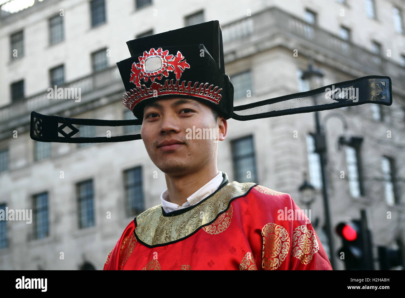 Man dressed in traditional Chinese costume during the Chinese New Year Parade, London, UK. Stock Photo