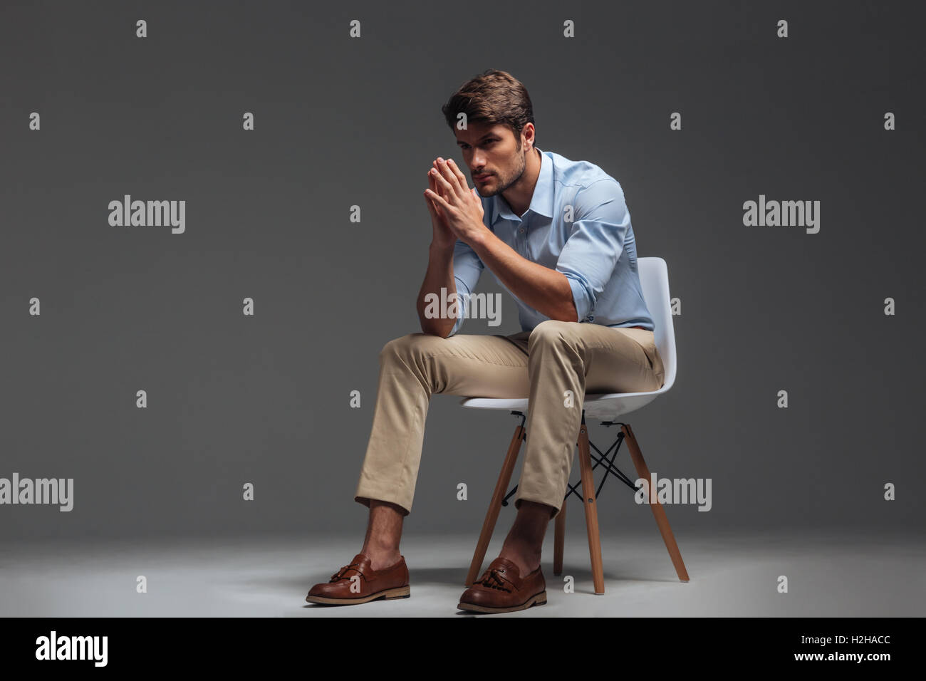 Handsome sad man sitting on hi-res stock photography and images - Alamy