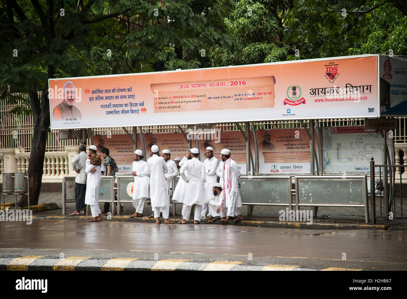 Indians muslim boy group  waiting at a bus stop in Mumbai Maharashtra India Stock Photo