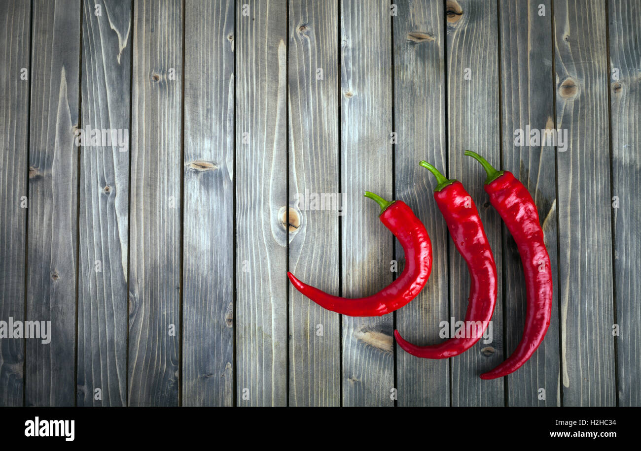 Red hot chili peppers on wood background Stock Photo - Alamy