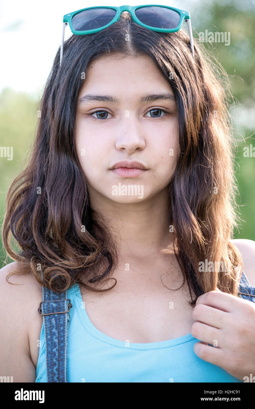Portrait of beautiful teen girl with sunglasses on head Stock
