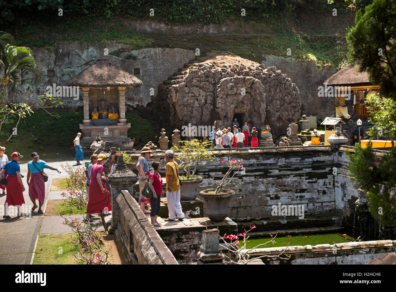 Indonesia, Bali, Goa Gajah, tourists at bathing pool in C11th elephant cave Hindu temple complex Stock Photo