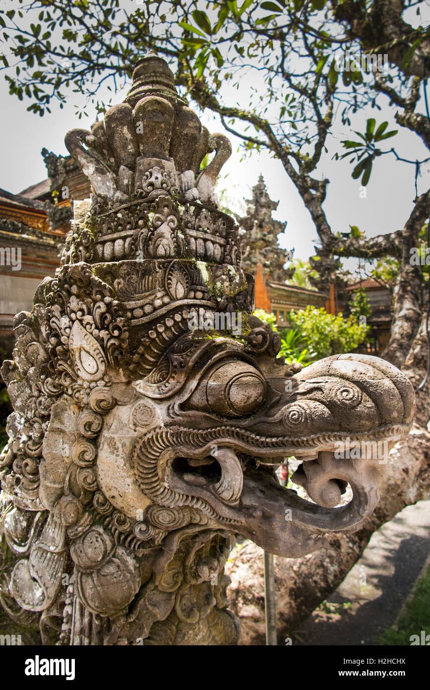 Indonesia, Bali, Ubud, Jalan Raya Ubud, carved stone figure guarding Pura Taman, Saraswati temple Stock Photo