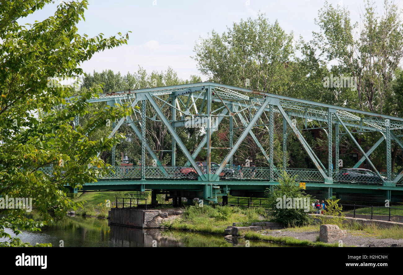 Cars and people cross bridge over the Lachine Canal close to Atwater Market,  downtown Montreal. Stock Photo