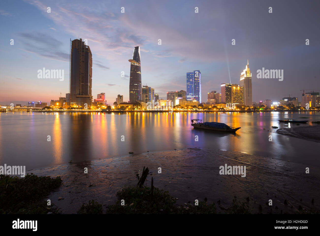 Sunset riverside along beautiful sparkling skyscrapers coal brighter show development in Ho Chi Minh city Stock Photo