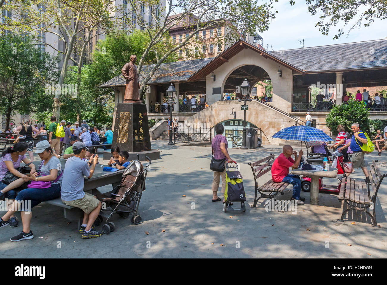 Families of  Chinese Americans in Columbus Park in Chinatown, New York City playing Chinese Chess, also known as, Xiangqi. Stock Photo
