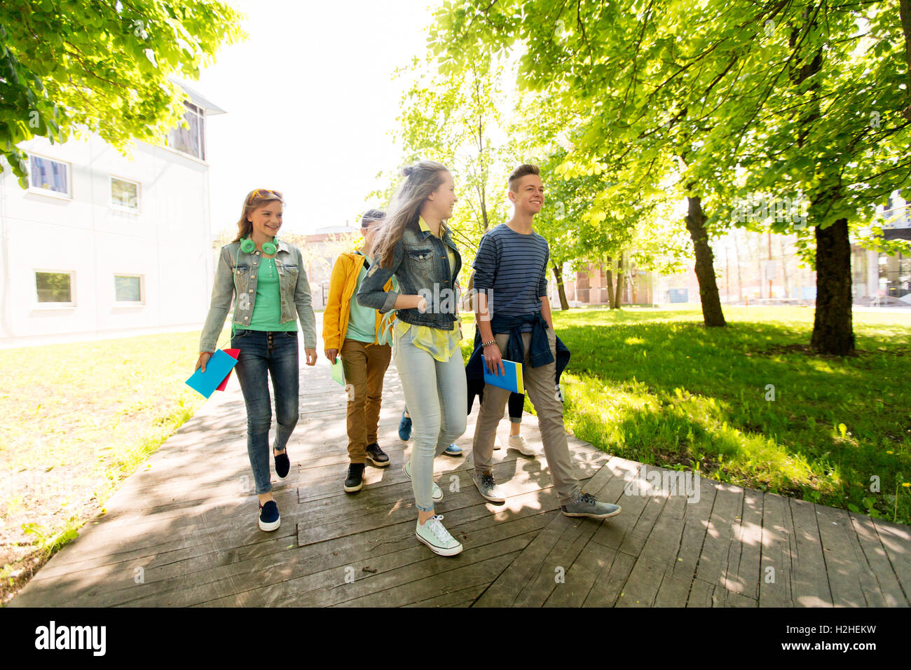 group of happy teenage students walking outdoors Stock Photo - Alamy