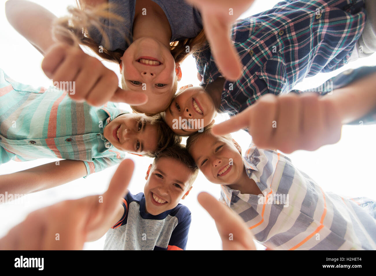 happy children showing thumbs up in circle Stock Photo - Alamy