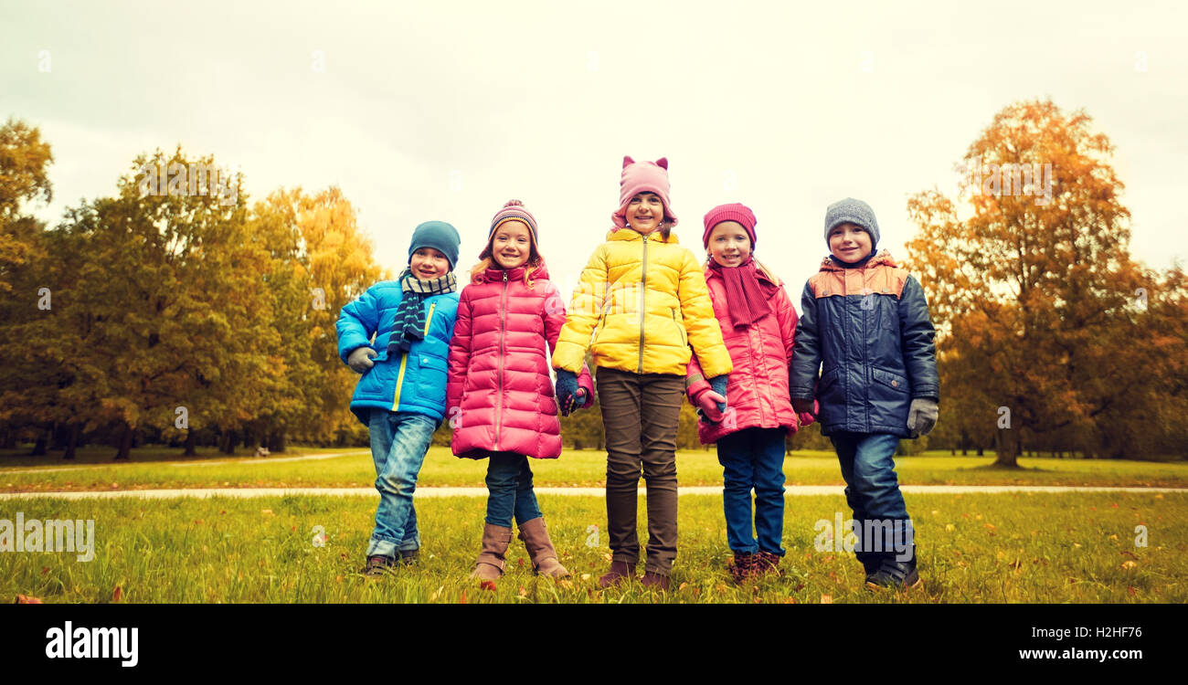 happy children holding hands in autumn park Stock Photo - Alamy