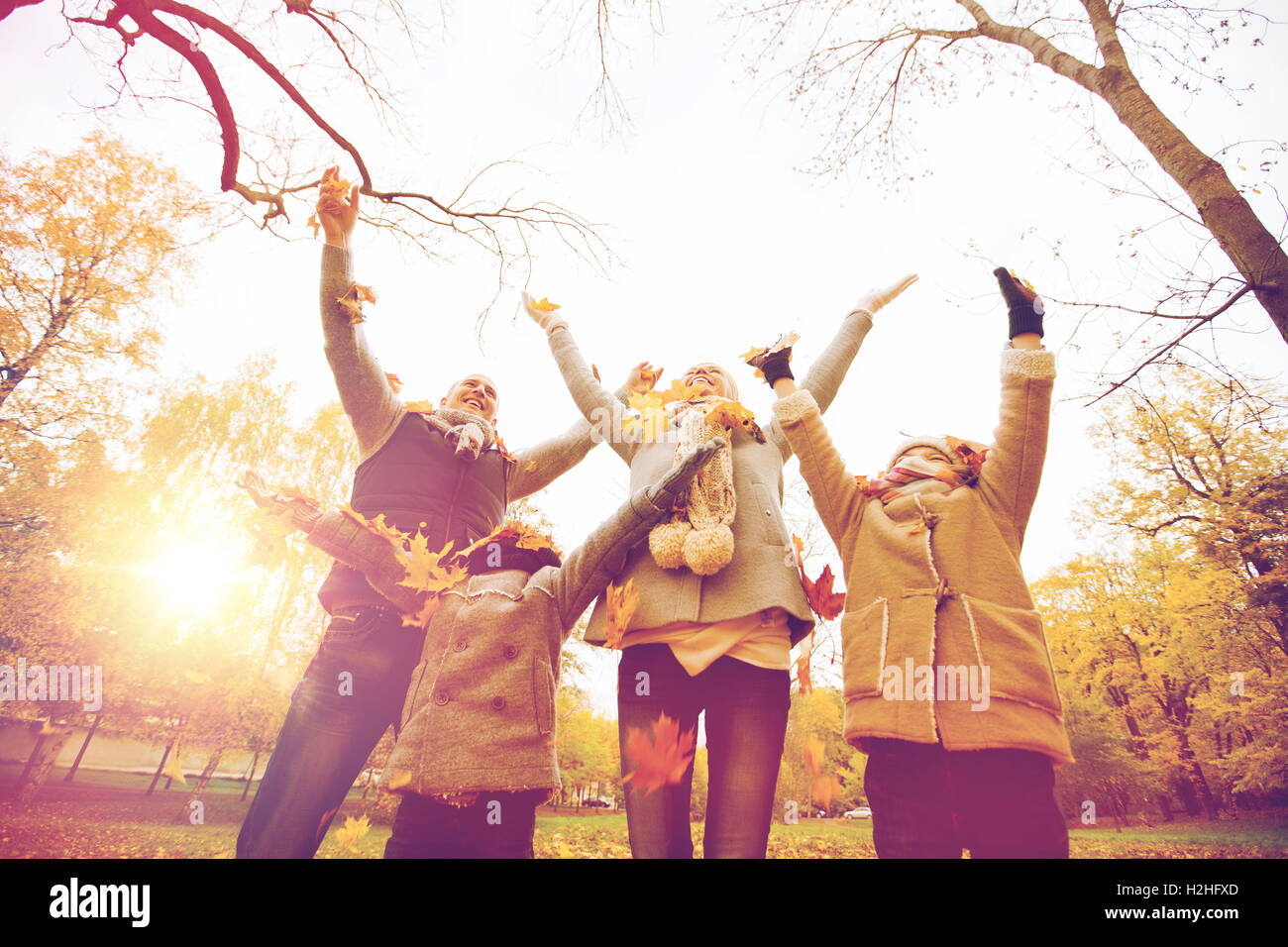 happy family playing with autumn leaves in park Stock Photo - Alamy