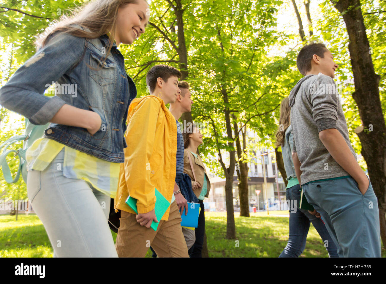 group of happy teenage students walking outdoors Stock Photo - Alamy