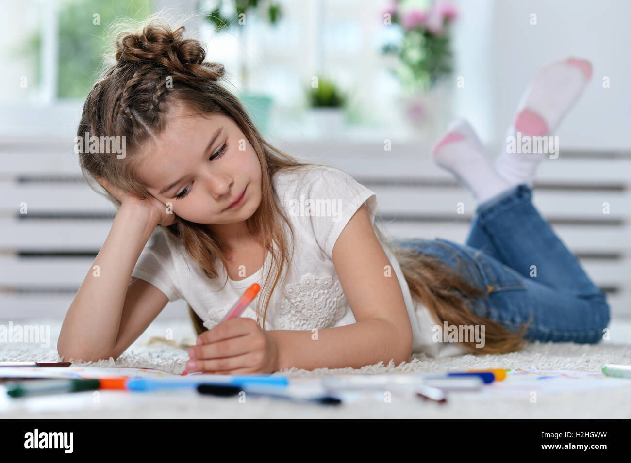 Little girl drawing at class Stock Photo - Alamy