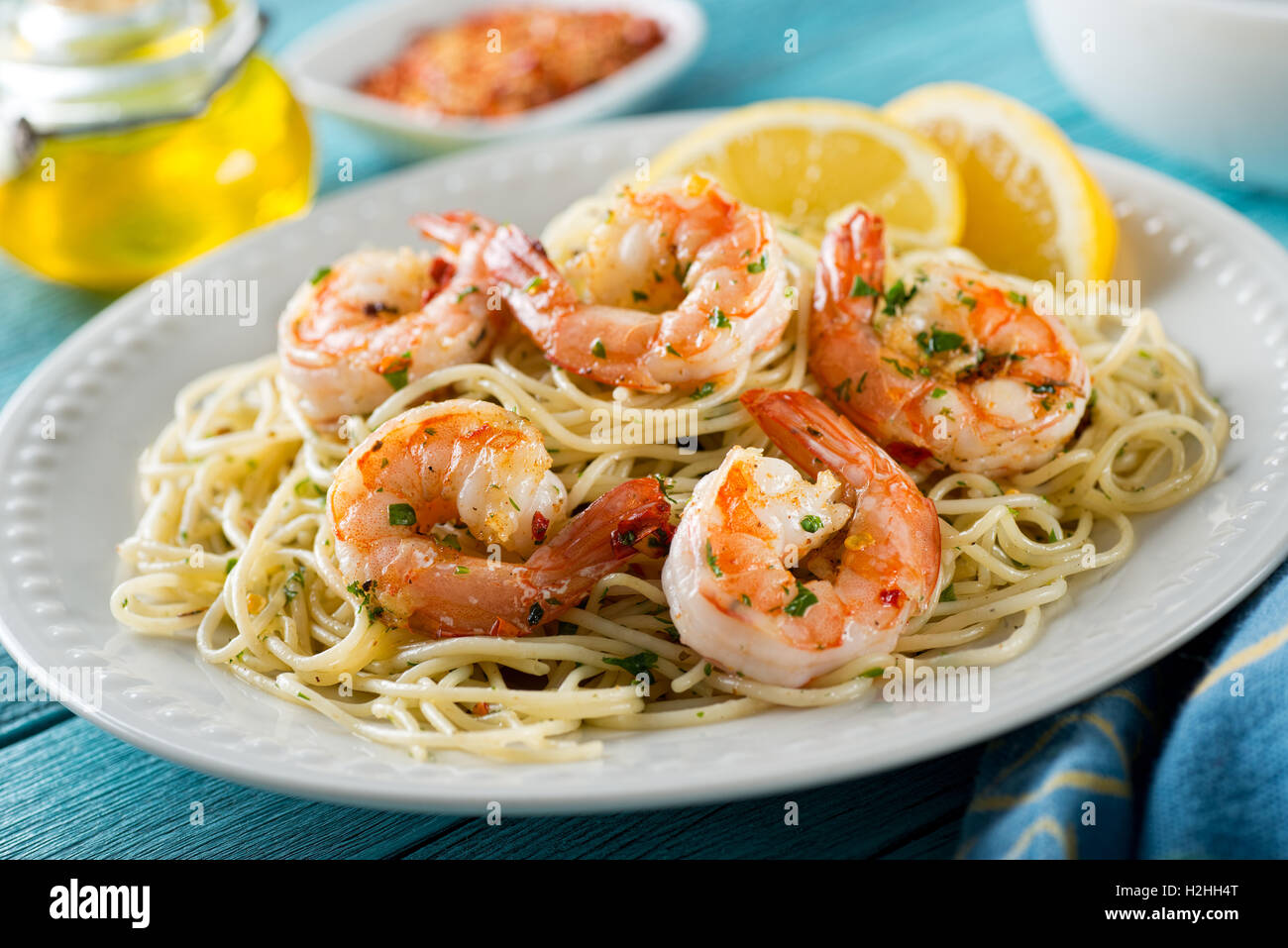 A delicious plate of shrimp scampi with spaghetti and lemon. Stock Photo