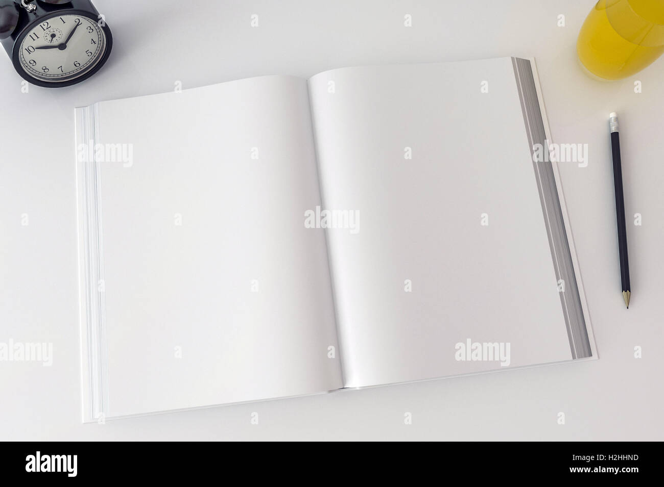 Open Book With Blank Pages Mock Up Old Clock And Juice On Desk Stock open-book-with-blank-pages-mock-up-old-clock-and-juice-on-desk-stock