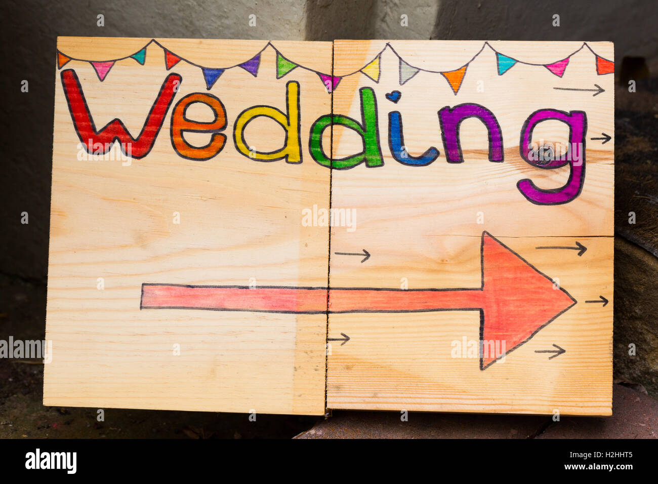 Bright, colourful sign point the way to a wedding Stock Photo