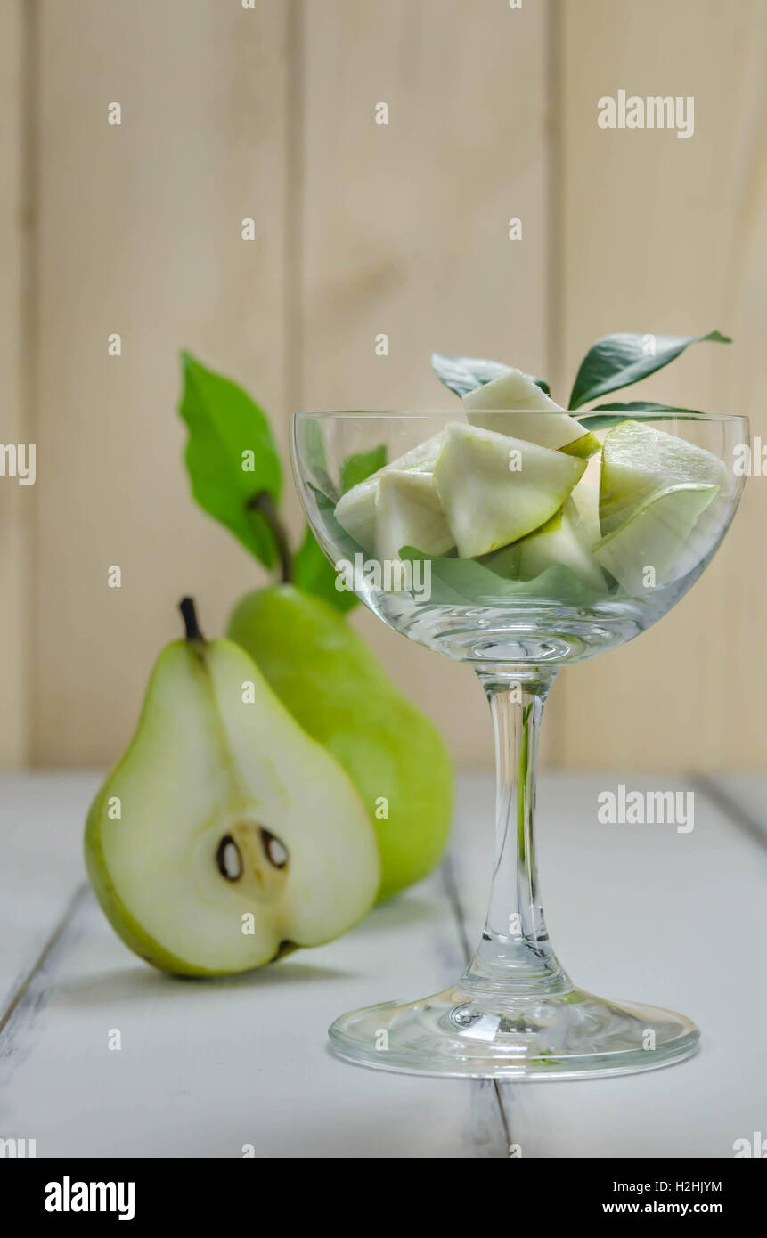 Slice of green pear in glass over white background Stock Photo