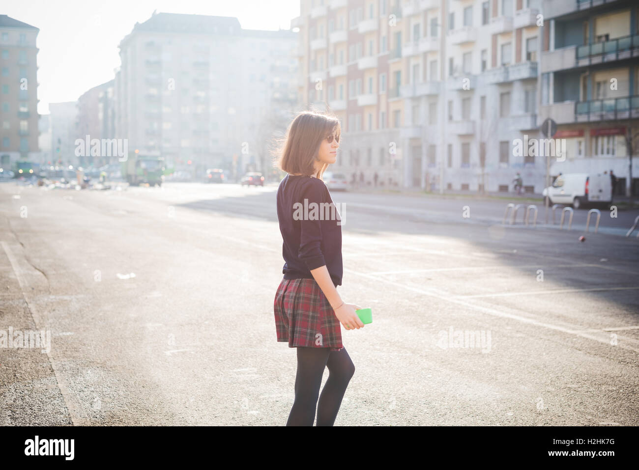 young pretty brown hair woman walking trough the streets using a ...