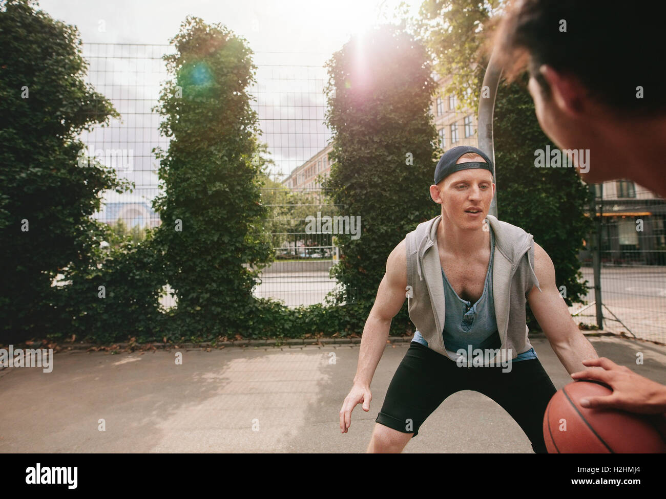 Two streetball players on the basketball court. Teenage friends playing streetball. Stock Photo