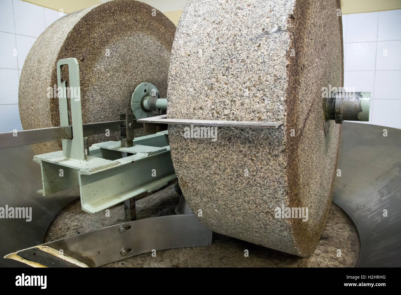 Grinding stone in olive oil factory Stock Photo