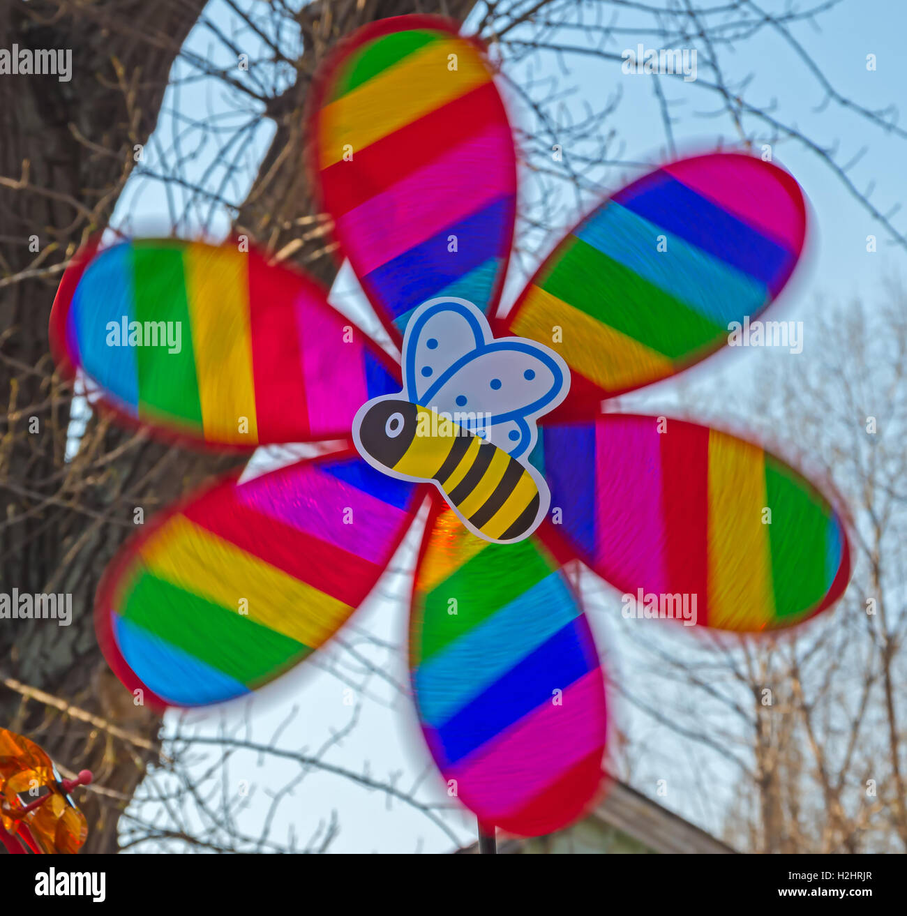 Children's multi-colored toy in the form of a propeller and bee in motion Stock Photo
