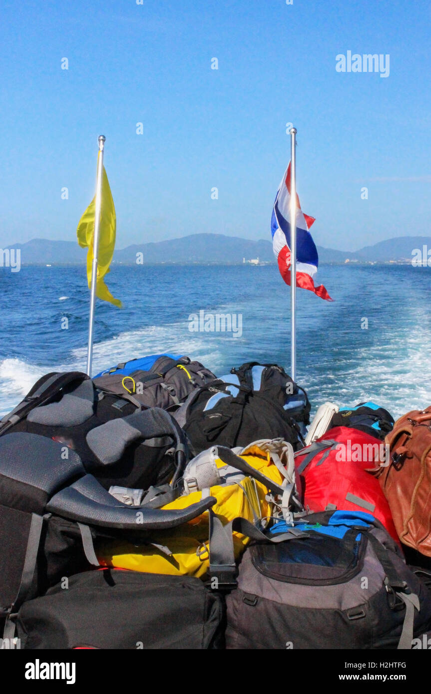 Stacked luggage and backpacks aboard of the heck a ferry during journey