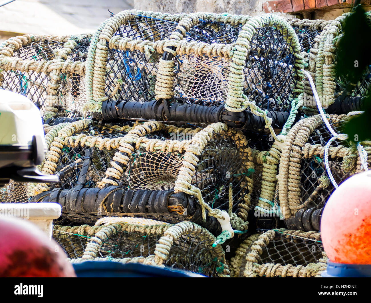 Crabbing baskets stacked up with other fishing paraphernalia Stock