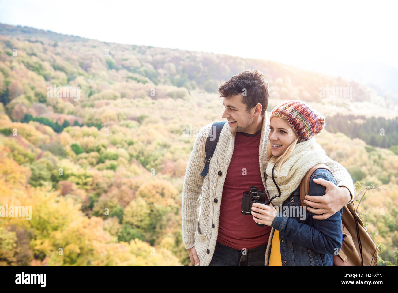 Young couple on a walk in sunny autumn forest Stock Photo - Alamy