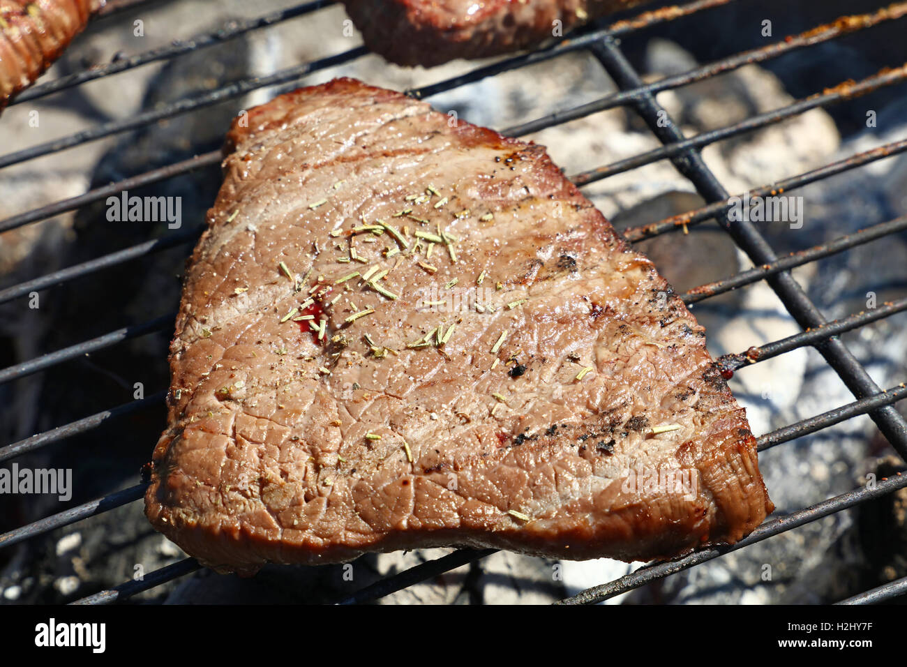 One grilled beef fillet barbecue steak with spices cooking prepared on