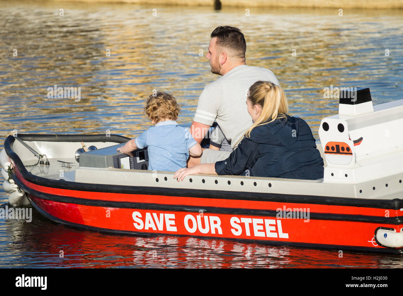 Young family on boating lake at Redcar, north east England. UK. Stock Photo