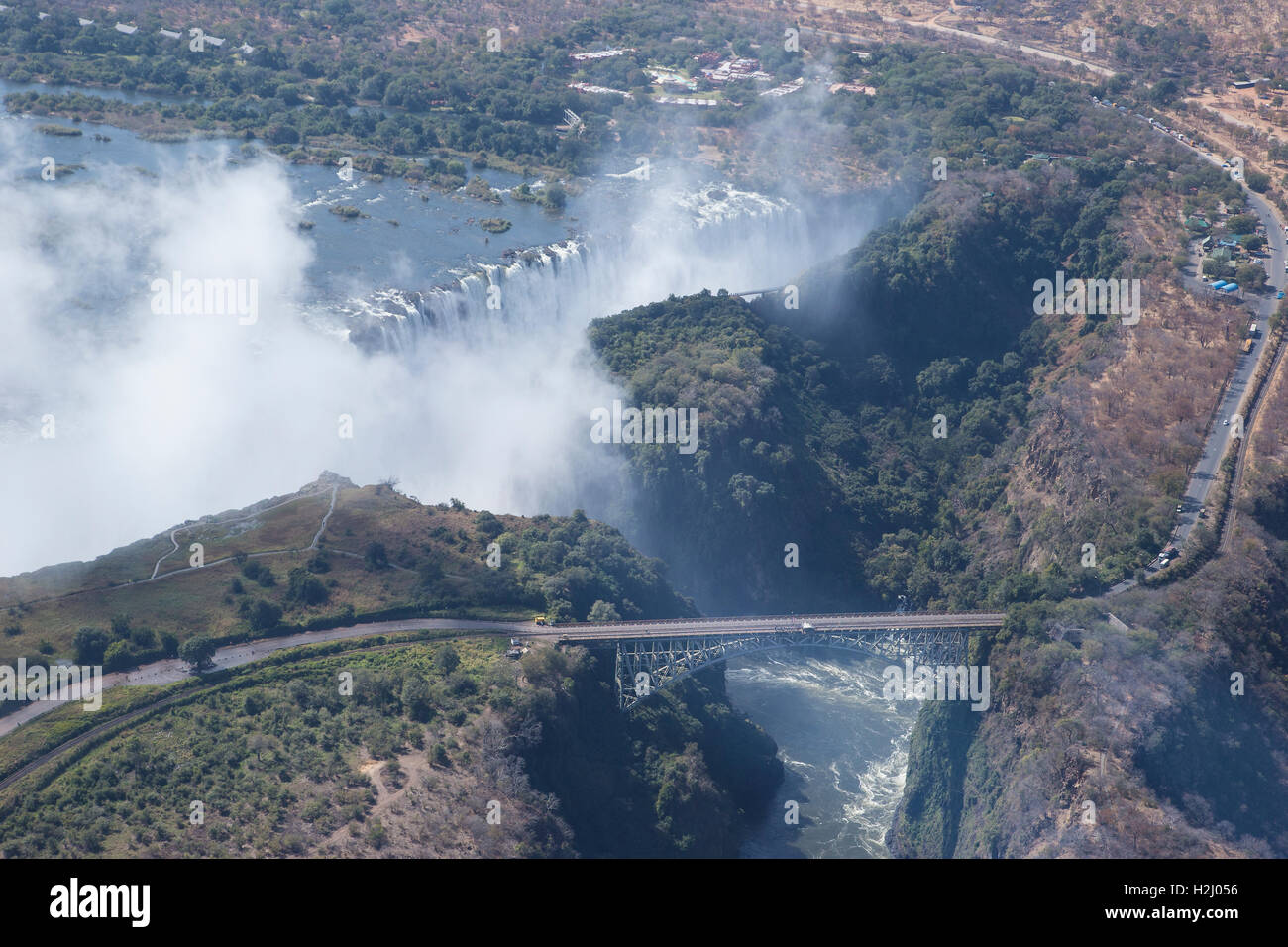 Aerial view of the Victoria Falls showing  the gorge that divides Zambia from Zimbabwe and Zambezi river that plunges into it Stock Photo