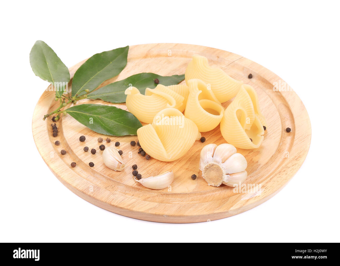Italian pasta shells on a wood plate Stock Photo - Alamy