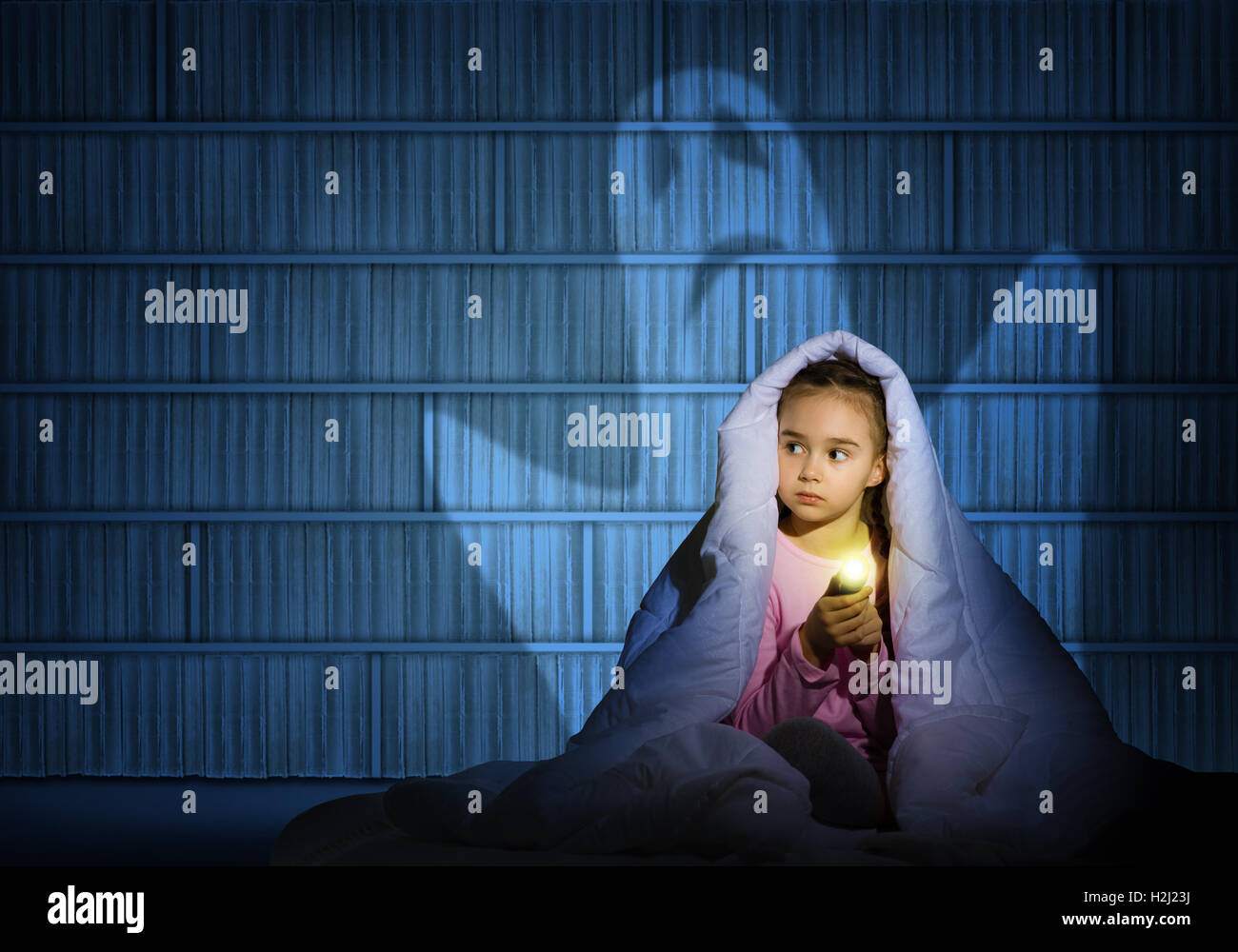 girl under the covers with a flashlight Stock Photo Alamy