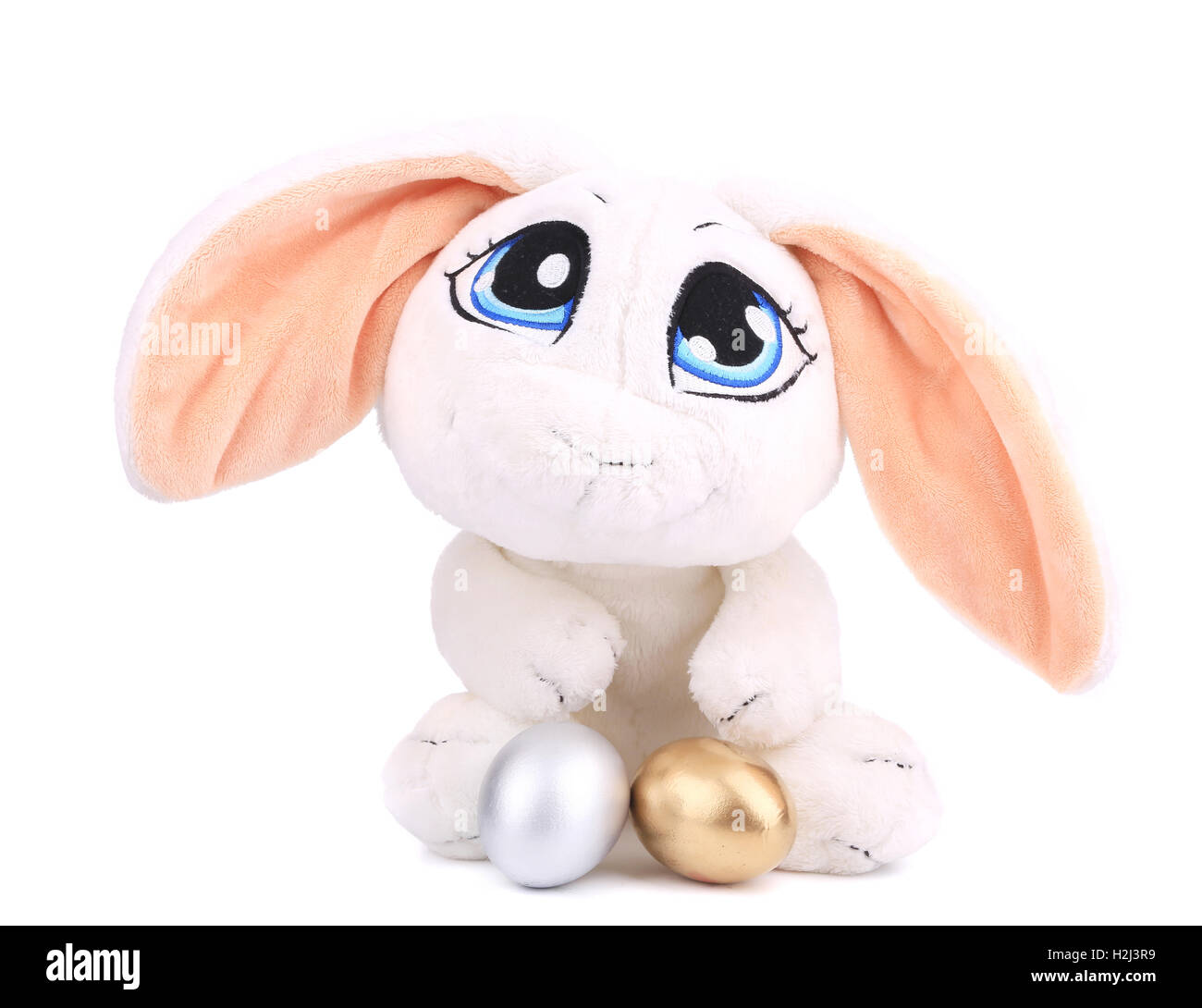 White toy rabbit with golden egg Stock Photo - Alamy