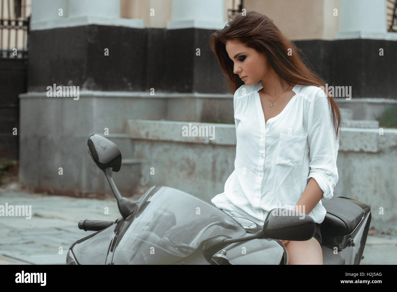 Biker girl rides a motorcycle in the rain. First-person view Stock Photo