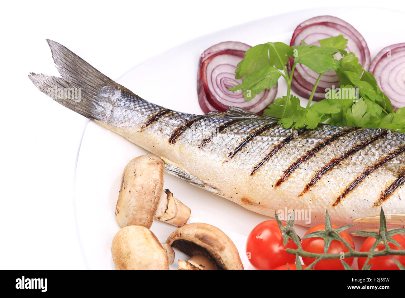 Grilled fish with red onion. Stock Photo