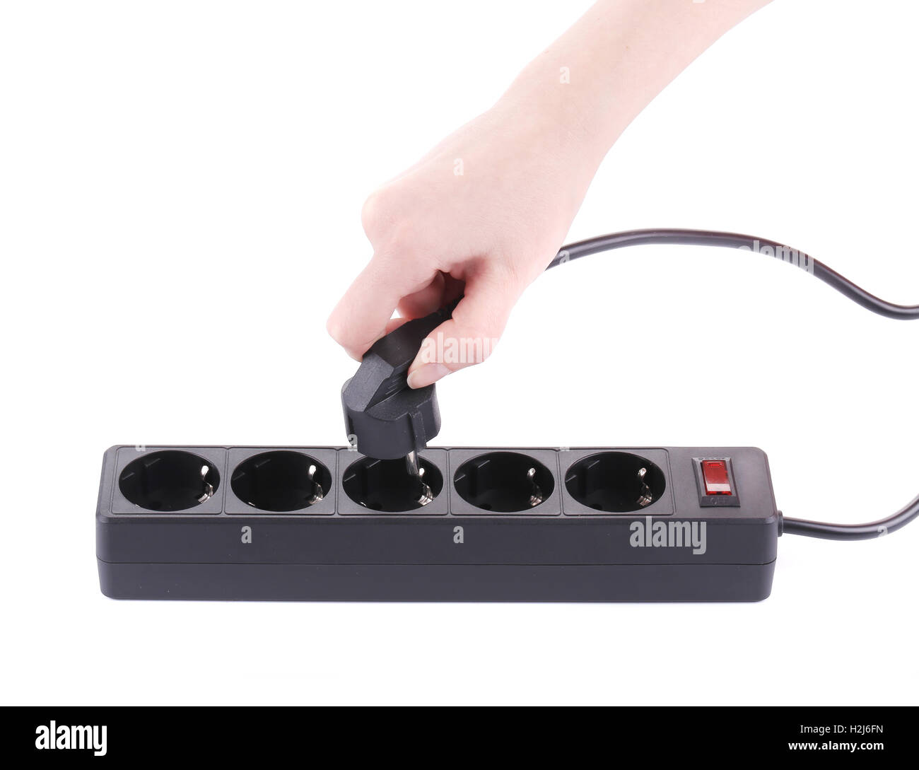Hand puts the plug in an extension cord Stock Photo Alamy