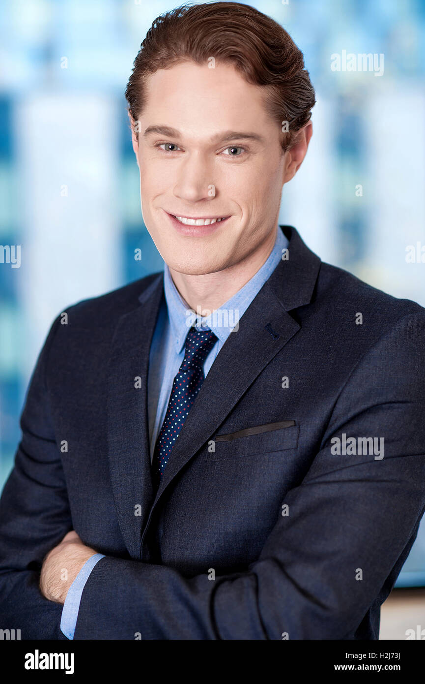 Happy young businessman smiling at the office Stock Photo - Alamy