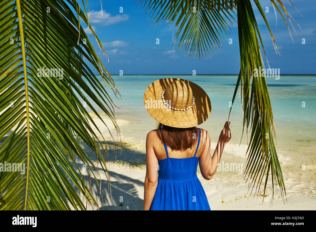 Woman in blue dress on a beach at Maldives Stock Photo - Alamy