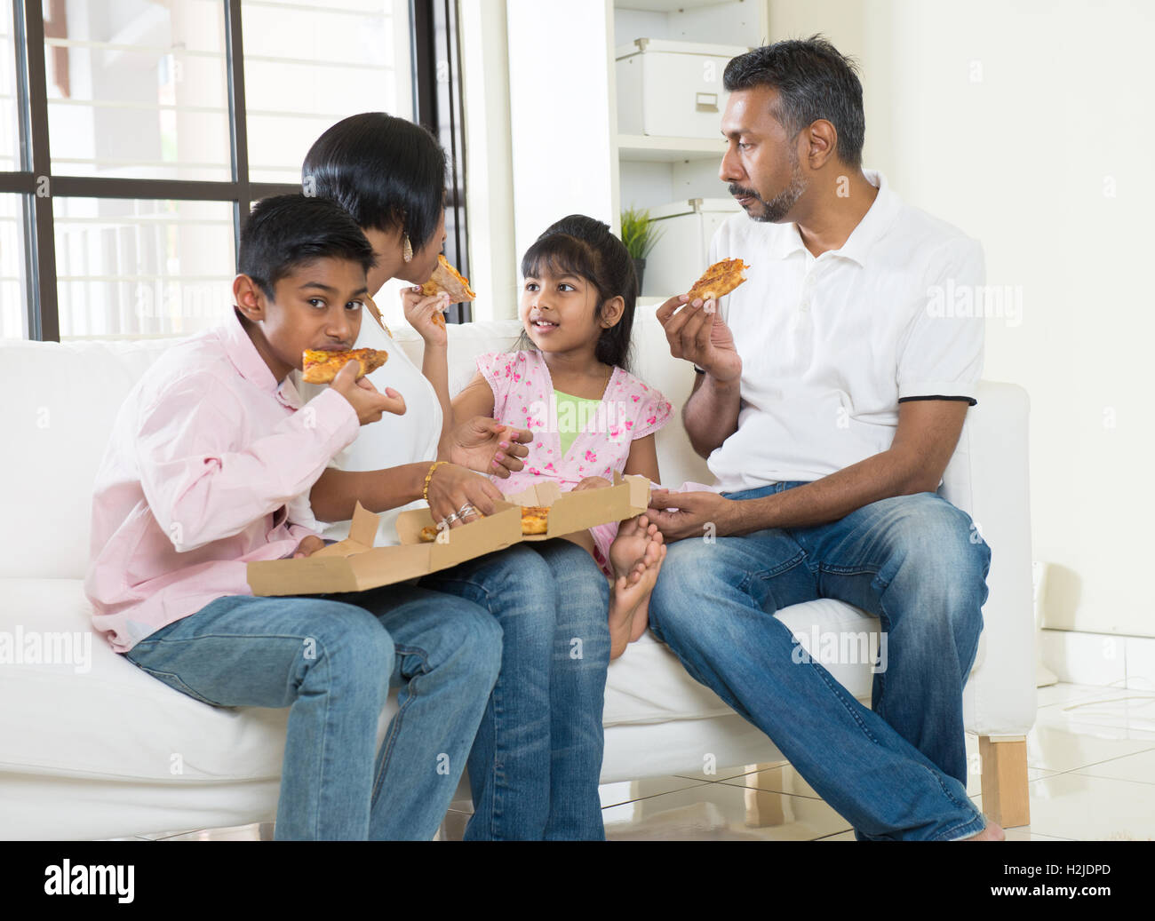 Indian family eating pizza hi-res stock photography and images - Alamy