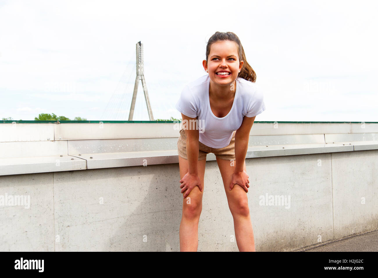 Focused runner outdoors resting with big smile Stock Photo
