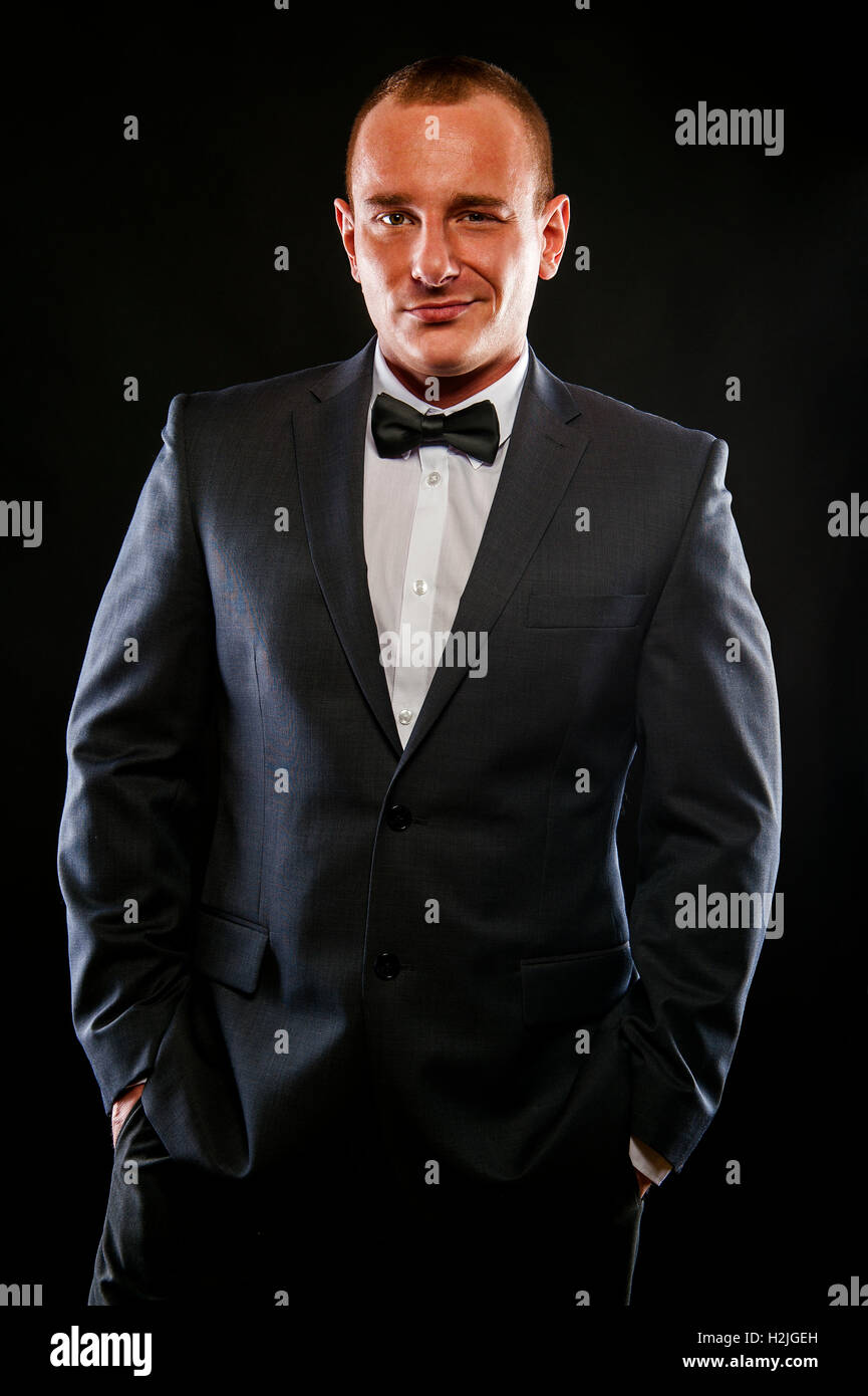 Portrait of handsome stylish man in elegant black suit Stock Photo - Alamy