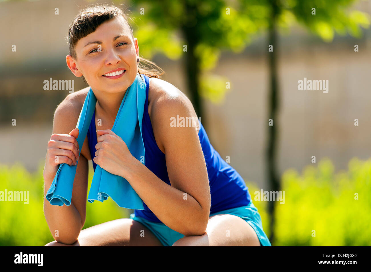 Active woman resting after jogging with towel. Smiling Stock Photo Alamy