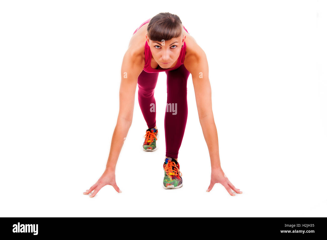 Young woman in ftness outfit prepare to run. isolated on white background. Stock Photo