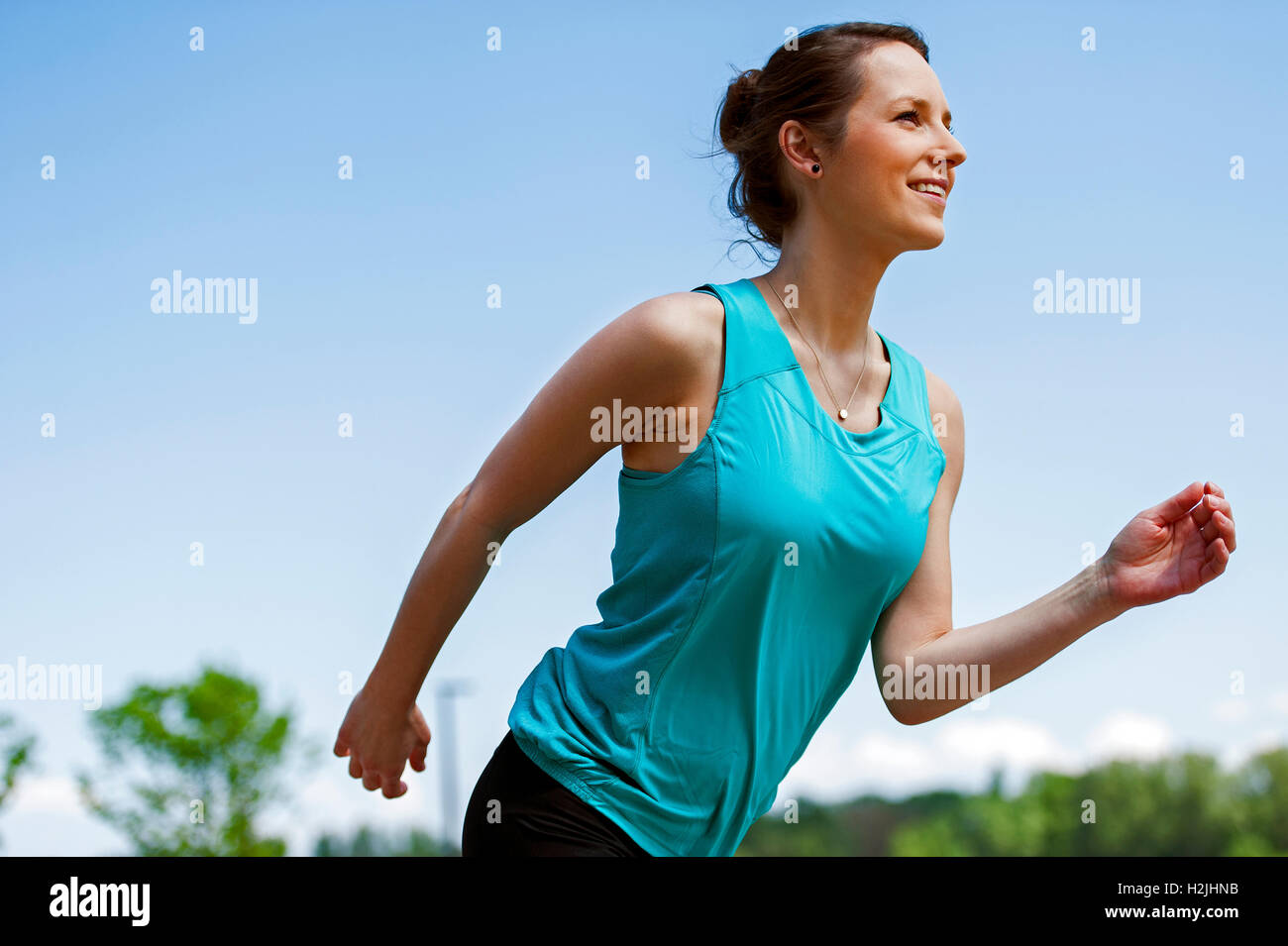 Fit woman jogging in park Stock Photo - Alamy