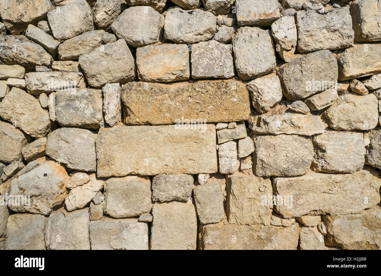 Traditional wall of stones built without lime. Dry stone wall. Stock Photo