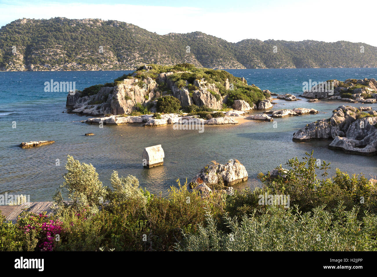 Little island and a lycian style sarcophagus in Kale Village along the Mediterranean coast of Turkey Stock Photo