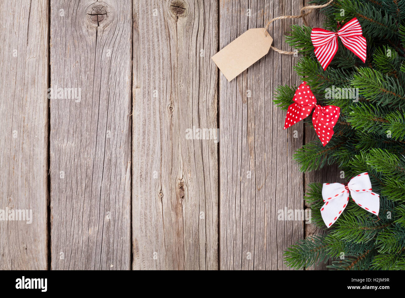 Christmas wooden background with fir tree and ribbon bow decor. View ...