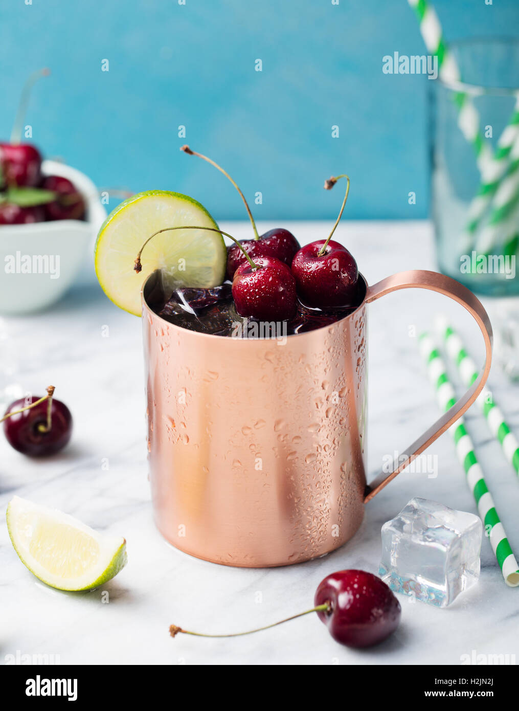Cold cherry Moscow Mules cocktail with ginger beer, vodka, lime Marble