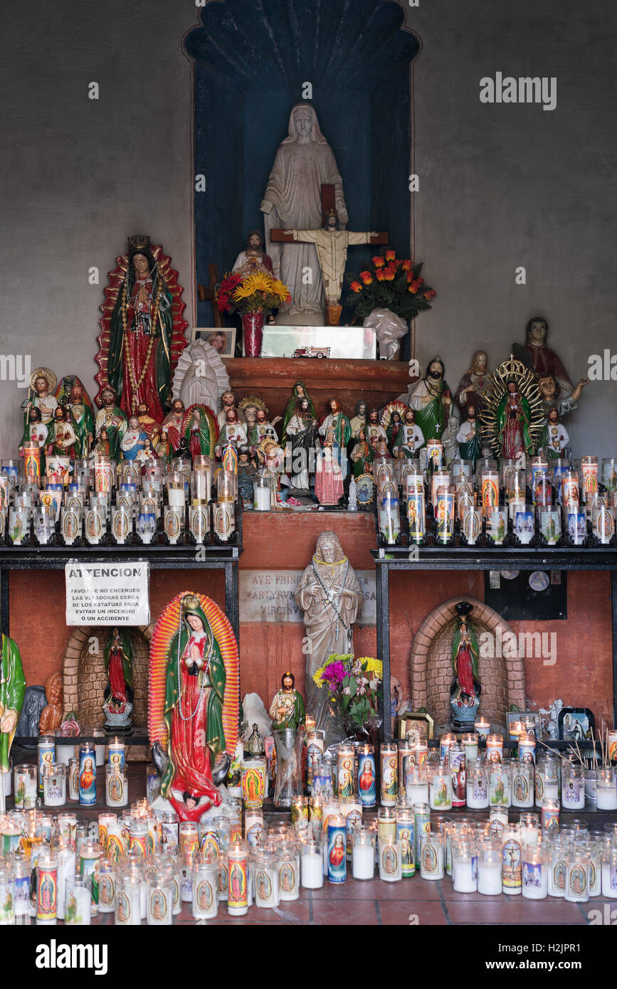 Candles and figurines in a Catholic church in Tuscon, Arizona Stock Photo