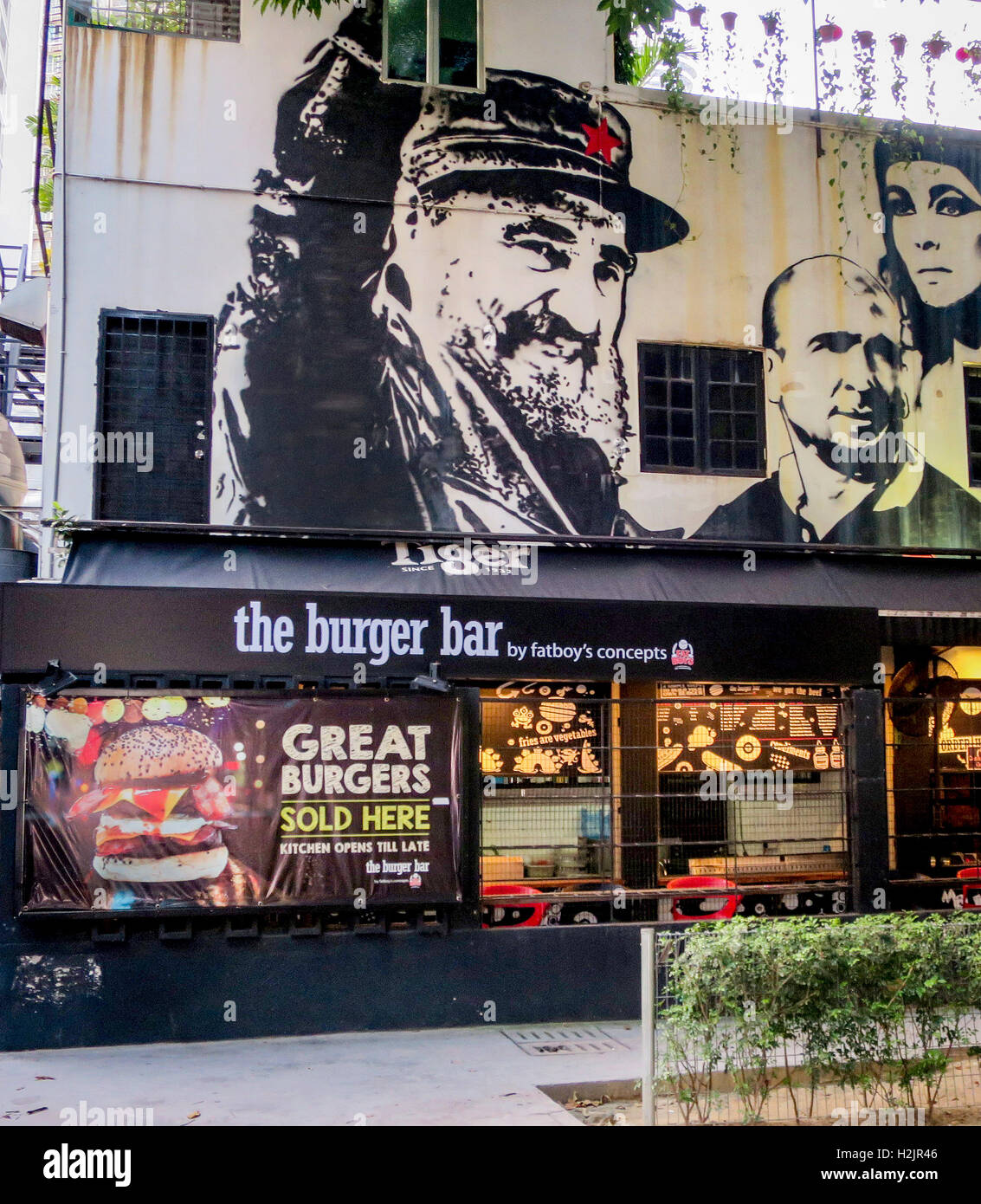 Portrait of Fidel Castro painted on a wall over a burger bar in Kuala Lumpur, Malaysia. Stock Photo